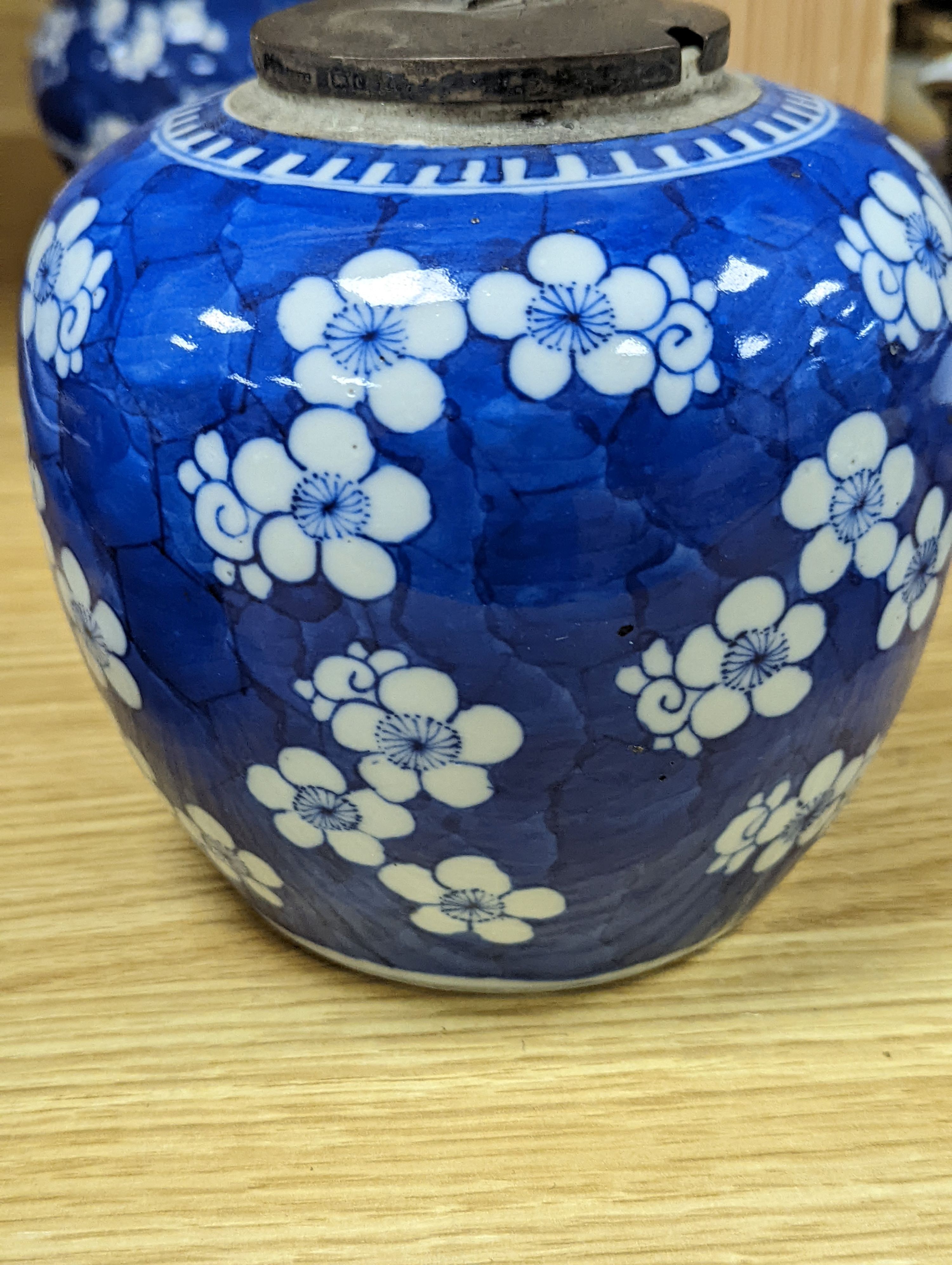 Three Chinese blue and white prunus decorated jars and covers, 19th/20th century, with four character marks 18cm